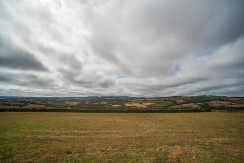 View from Castle Dore looking west across rolling Cornish countryside fields Stock Photos