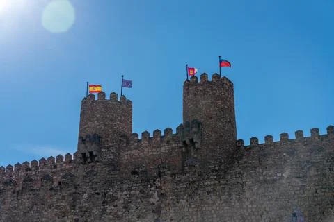 View of Castle External Wall with Two Towers and Multiple Flags Stock Photos