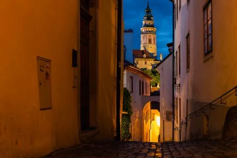 View of castle tower during sunset with street lighting across narrow street  Stock-Fotos