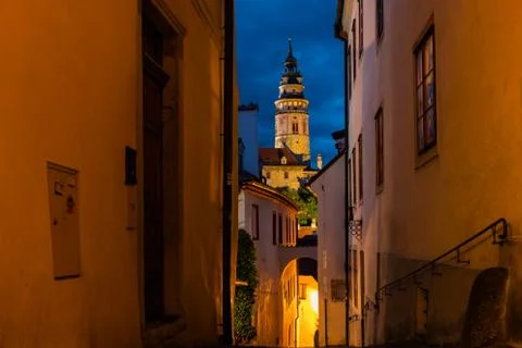 View of castle tower during sunset with street lighting across narrow street  Stock-Fotos