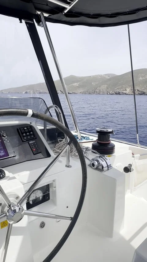 View from Catamaran Cockpit While Sailing Past Greek Island Stock Footage 336964988
