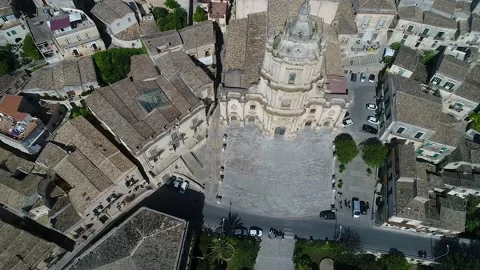 View of Cathedral flying backward revealing old town Modica in Sicily Stock Footage 179499666