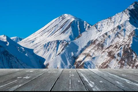 View of Caucasian Mountain in winter with empty wooden table. Natural templat Stock Illustration