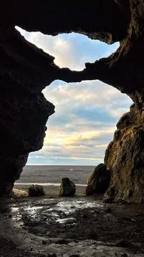 View from the cave and blue clouds sky. Stock Photos