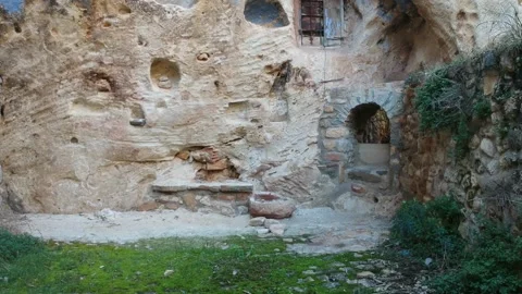 View of a cave house wall with a drone Stock Footage 126899533