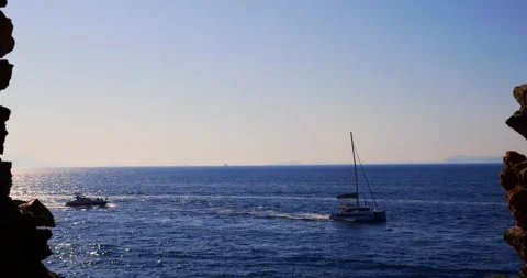 View from the cave to the sea with motorboats Stock Footage 315677331