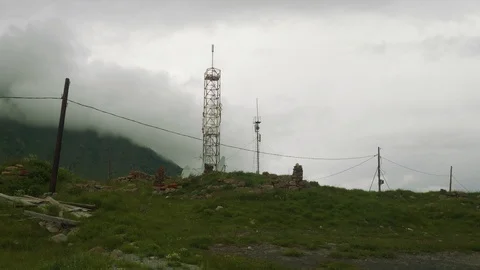 View of cell tower set using old stones high in Ossetian mountains Stock Footage 93749877