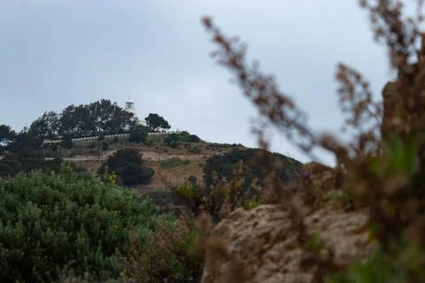 View of the Ceuta lighthouse on Monte Hacho on a cloudy day Stock Photos