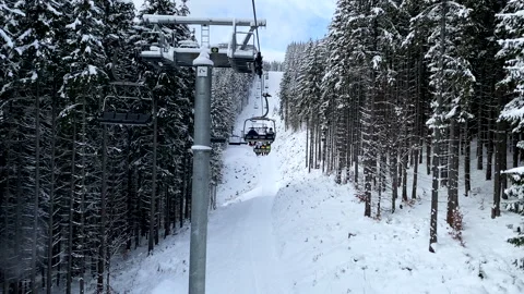 View of chair lift pine tree covered with snow ski resort Video stock 247689917