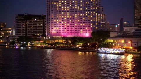View of the Chao Phraya River and Bangkok City at night with boats Stock Footage 247450746