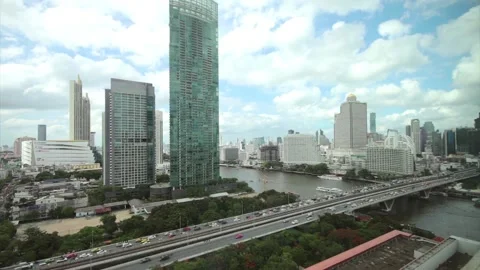 View of the Chao Phraya River, overlooking the Taksin Bridge and the BTS train. Stock Footage 140775173