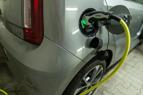 View at a charging electric car by a pluged in type 2 charging wire, green light Stock Photos