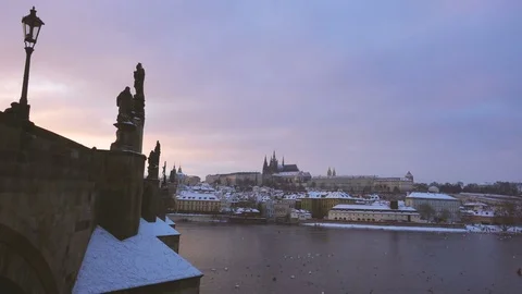 View of Charles Bridge and Castle in Prague Under the Snow in Winter at Sunset Stock Footage 72099859