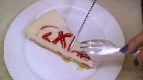 Up view of cheese cake on white plate. Woman cut in with knife and take a piece Stock Footage 127167607