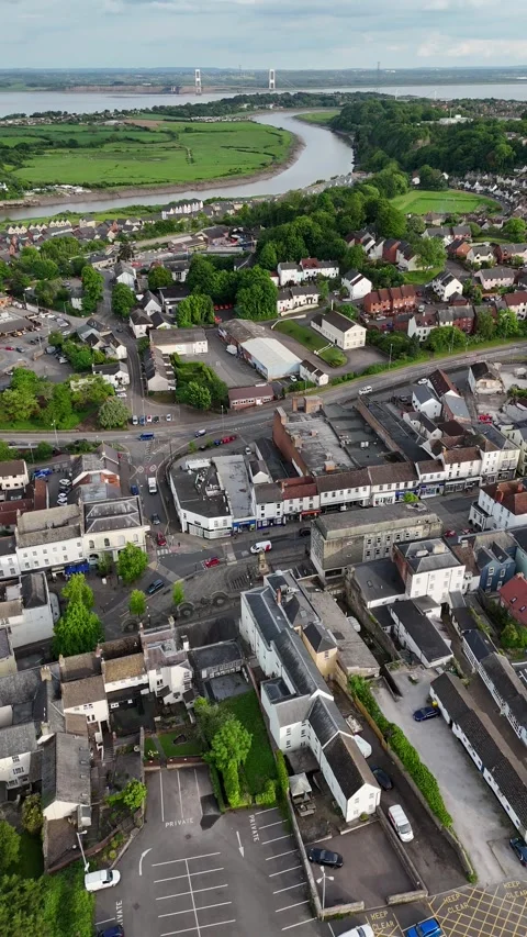 View of Chepstow as the River Wye flows toward the M48 bridge, Wales Stock Footage 294932273