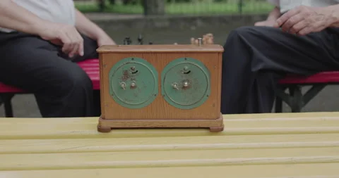 View of chess clock. Player's hands turn on the button during game on bench 스톡 동영상 131868887