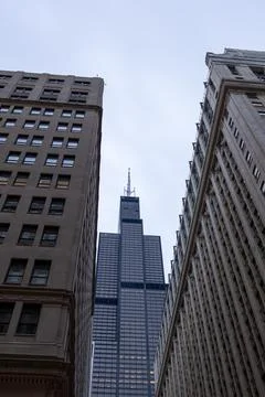 View of Chicago skyline with Sears Tower between tall buildings on a cloudy.. Фото
