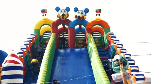 View of children playing on a colorful inflatable slide, Bangladesh. Video stock 335016534