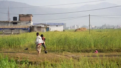 View of children playing in a field in Surkhet, Nepal. 動画素材 335467649
