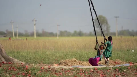 View of children playing on a rope swing in Dhangadhi, Nepal. Video stock 335476838