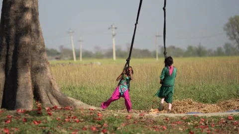 View of children playing on a rope swing in Dhangadhi, Nepal. Video stock 335476862