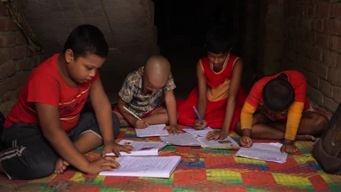 View of children studying and writing in notebooks, Bangladesh. Stock-Footage 335585551