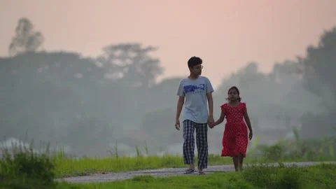 View of children walking along a rural road in Bogura, Bangladesh. Video stock 335585960