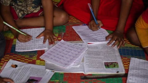 View of children writing in notebooks and studying, Bangladesh. Video stock 335585522
