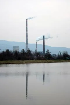 View of the chimneys with white smoke, reflected in the water Stock Photos