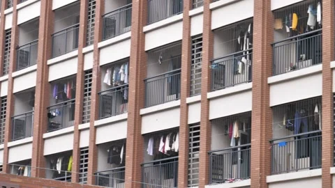 A view of a Chinese university dormitory building with rows of balconies. Vídeos de archivo 300752860