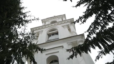 View of Church through pine tree branches. Russia. Blue sky with grey cloud Stock Footage 161071808