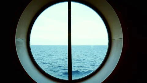 View from the circle window on the cruise overlooking the distant sea waves Stock Footage 237457522