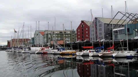 View to the city and boats tied at the harbor in Trondheim, Norway. Stock Footage 59659357
