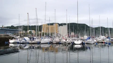 View to the city and boats tied at the harbor in Trondheim, Norway. Stock Footage 59661565