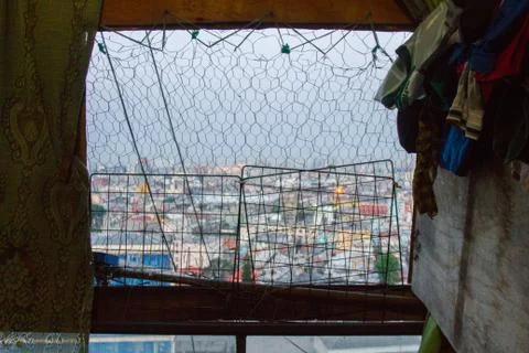 View of the city from a decayed window. Stock Photos