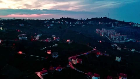 View of a city at dusk with a hill in the background Stock Footage 267676314
