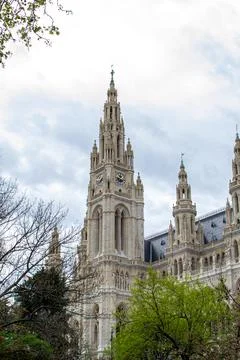 View of the City Hall clock tower through the tree branches Foto stock