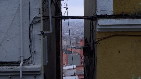 View of the city from a high point through the gap between the houses. Cloudy Stock Footage 98457952