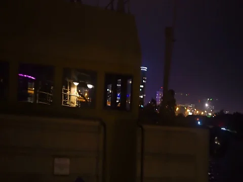View of the city at night aboard an old boat Stock Footage 71861109