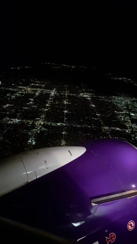 A view of a city at night from a plane window, vertical video, 4K Stock Footage 227054574
