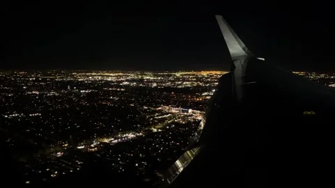 A view of a city at night from a plane window, 4K Stock Footage 261097620
