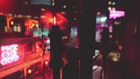 A view of a city at night from a window Ilustración de archivo