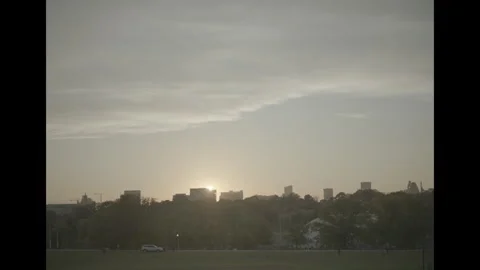 View of city from park at sundown Video stock 285474450