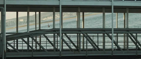 View of a city port through an old metal bridge. Slow motion. Stock Footage 147565547
