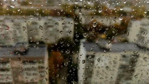 View of the city through a wet window in drops of water during the rain. Stock Footage 151721157