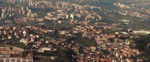 View of city from the window of an airplane after take off on a sunny day Stock Footage 127135653