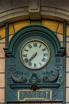 View of classic retro wall clock at the train station of St. Bento in Porto c Stock Photos