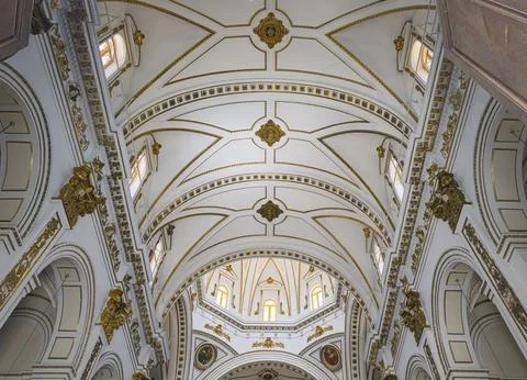 View of classical church ceiling with gold trim and arched windows on a cle.. Fotos de archivo
