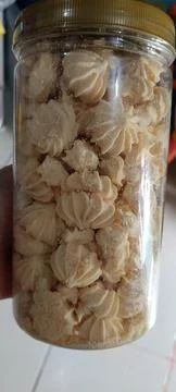 View of a clear jar full of crispy cookies Stock Photos