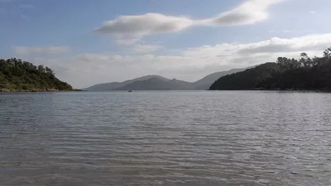 A view of clear sky and hills in the morning from a beach. 스톡 동영상 143443583